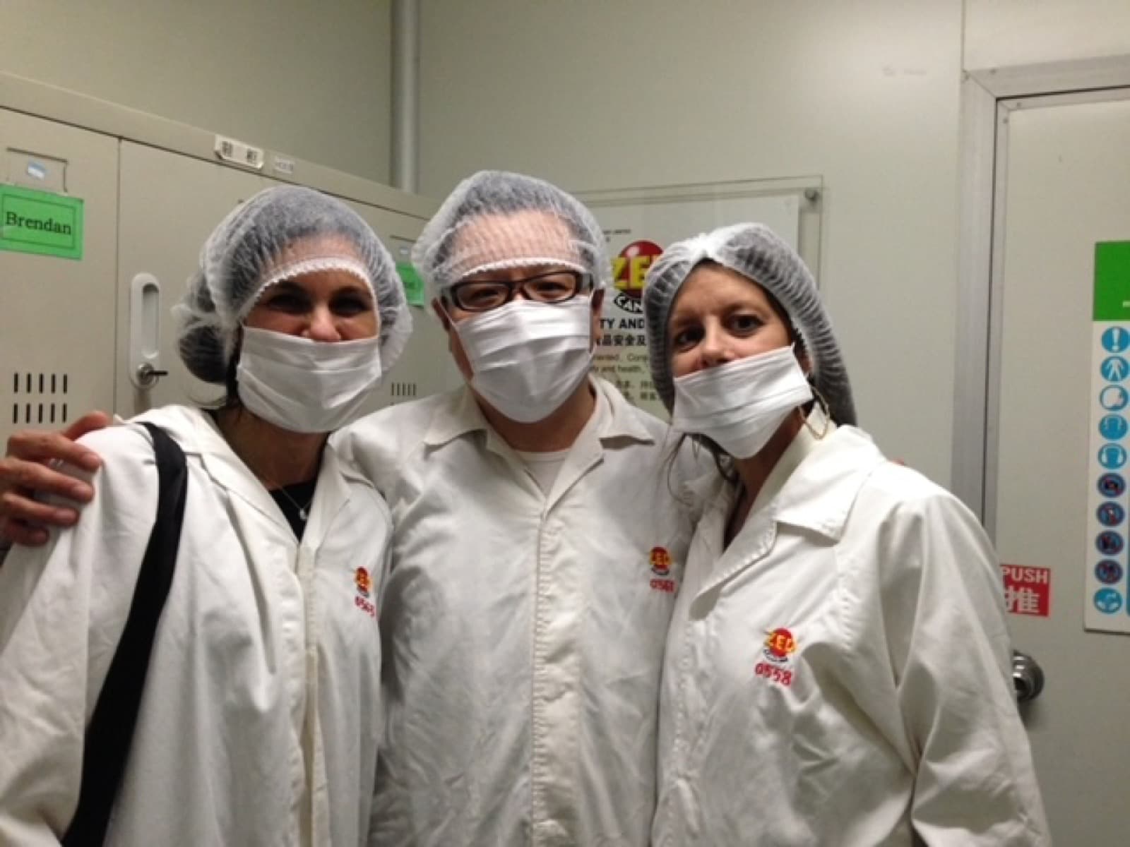 Amy Katz and Donna Slavitt visiting a production facility in protective equipment